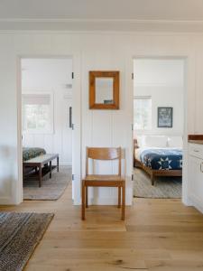 a bedroom with a bed and a chair and a mirror at Dawn Ranch in Guerneville