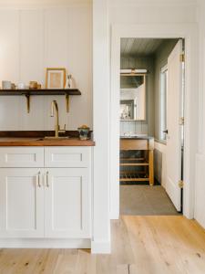 a kitchen with white cabinets and a sink at Dawn Ranch in Guerneville