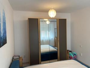 a bedroom with a closet with a mirror and a bed at Sweet Home Sibiu in Sibiu