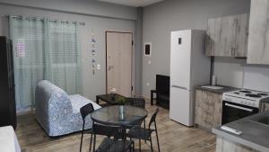 a kitchen with a table and chairs in a kitchen at Vasiliki Studios Tolo in Tolo