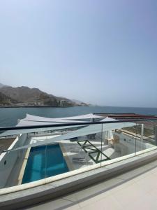 a swimming pool on the roof of a building with the ocean at The Pearl Villa 5 bedrooms with pool Sea and Mountain View in Fujairah