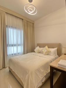 a bedroom with a large white bed with a window at The Pearl Villa 5 bedrooms with pool Sea and Mountain View in Fujairah