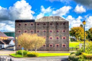 a large brick building with a sign on it at Cosy Coastal Cottage in Portballintrae in Portballintrae +11 photos