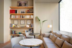 a living room with a couch and a table at AC Hotel Aitana by Marriott in Madrid