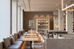 una lunga fila di tavoli e sedie in un ristorante di AC Hotel Aitana by Marriott a Madrid