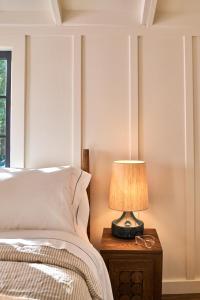 a bedroom with a bed and a lamp on a night stand at Dawn Ranch in Guerneville