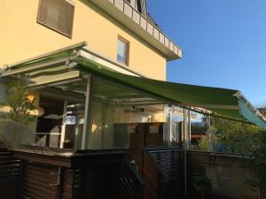 awning on a porch of a house with at Zwischen See und Stadt in Klagenfurt