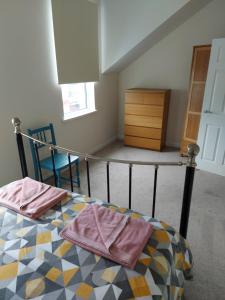 um quarto com uma cama com duas toalhas em Atrium Apartment A em Bangor