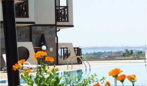 a house with a swimming pool with orange flowers at Dream Villa in Imperial Heights Villas in Sunny Beach