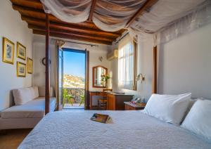 a bedroom with a bed and a living room at Paradision Hotel in Tourlos