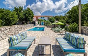 a patio with two chairs and a swimming pool at 3 Bedroom Nice Home In Smrika in Šmrika