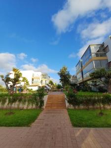 a brick walkway in front of a building at Sidi Rahal Bleu Beach family in Sidi Rahal