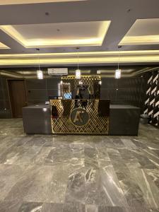 a lobby with a reception desk and a marble floor at Cast Home in Ahad Rafidah