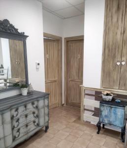 a room with wooden cabinets and a mirror at Grotta dei Puntali B&B in Carini