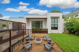 a house with a patio with chairs and a table at central contemporary w/ POOL and SPA in Austin