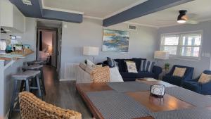 a living room with a couch and a table at Sea-La-Vie, your beach house oasis in Freeport