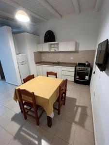 cocina con mesa y sillas y TV en Olivares de Krishna en San Fernando del Valle de Catamarca