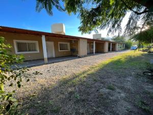 a row of buildings with a yard in front at Olivares de Krishna in San Fernando del Valle de Catamarca