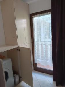 a kitchen with a window and a washing machine at CASA FRANCESCA in Assergi