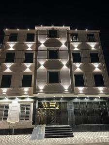 a large white building with lights on it at night at Cast Home in Ahad Rafidah