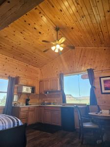 a kitchen with a ceiling fan and a table at Grandpa's Cabin in Apple Valley +24 photos