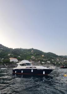 a black and white boat in the water at Amalfi Coast Yacht in Minori