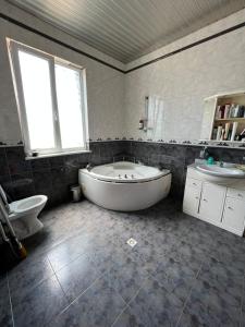 a bathroom with a tub and a toilet and a sink at Erik in in Tbilisi City