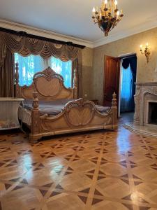 a bedroom with a bed and a fireplace and a chandelier at Erik in in Tbilisi City