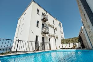 a building with a swimming pool in front of it at SkyView apartments in Herceg-Novi