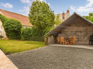 a patio with a table and chairs in a backyard at Swift Cottage in Chilton Polden 