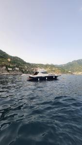 a boat sitting in the water on a lake at Amalfi Coast Yacht in Minori