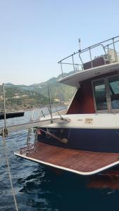 a boat tied to a dock in the water at Amalfi Coast Yacht in Minori