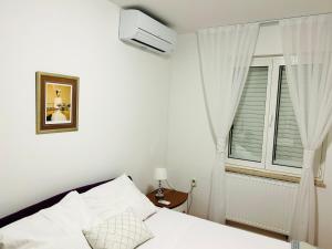 Posteľ alebo postele v izbe v ubytovaní Apartment Tina