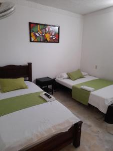 Postel nebo postele na pokoji v ubytování HOTEL NUEVO SOL