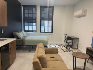 a living room with a couch and a bed at Hartford Downtown: 2mins walk to XL Center in Hartford