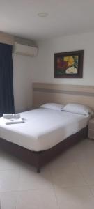 a large bed in a room with at HOTEL GUADALUPE BGA in Bucaramanga