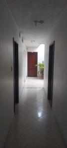 an empty hallway with a door in a room at HOTEL GUADALUPE BGA in Bucaramanga