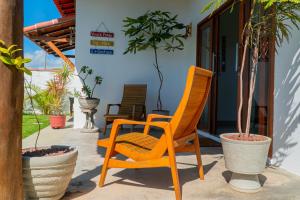 two chairs and potted plants on a patio at Rosa dos Ventos em São Miguel do Gostoso in São Miguel do Gostoso +35 photos