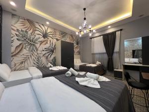 a hotel room with two beds and a chandelier at Mudem Boutique Hotel in Istanbul