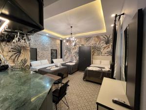 a living room with two beds and a kitchen with a counter at Mudem Boutique Hotel in Istanbul