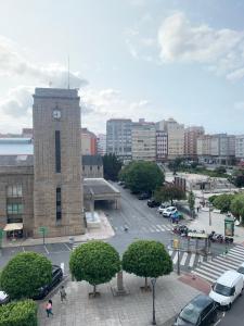 a building with a clock tower in a city at Apartamento turístico A Coruña in A Coruña