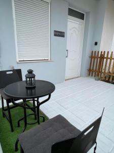 a room with a table and chairs and a door at Souzana Suite Leptokarya in Leptokarya