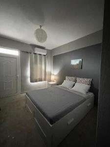 a bedroom with a large bed in a room at Souzana Suite Leptokarya in Leptokarya