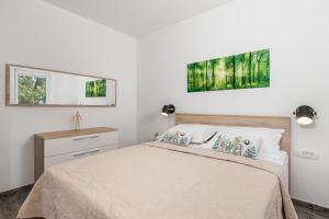a bedroom with a bed and a mirror at Apartmants Belvedere Rijeka in Rijeka