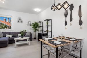 a living room with a table and a couch at Apartmants Belvedere Rijeka in Rijeka