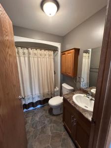 a bathroom with a toilet and a sink at Betula Lake Resort in Seven Sister Falls
