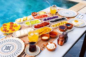 a table with many plates of food and drinks at Marrakesh Alaçatı in Ildır