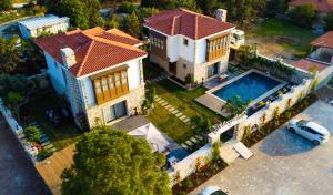 an aerial view of a house with a swimming pool at Marrakesh Alaçatı in Ildır