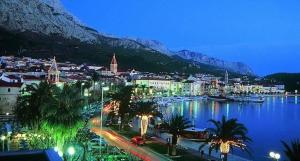 a city with a harbor with a city and a mountain at Ellamar City Center Apartment 2 in Makarska