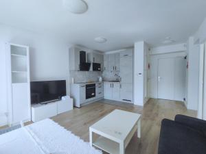 - un salon blanc avec un canapé et une table dans l'établissement Cozy Sunshine Apartment with Balcony 4 persons max, à Ivry-sur-Seine